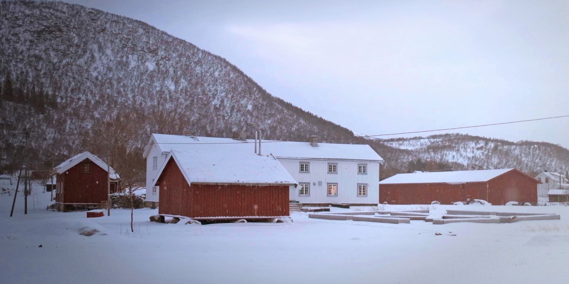 Kvitnes Bauernhof. Rot-weiße Bauernhäuser im Winter