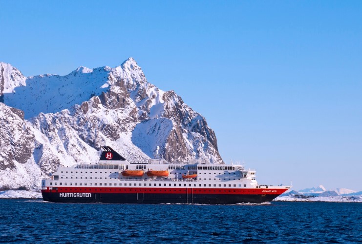 MS Richard With sailing in front of a snow-capped mountain in Norway